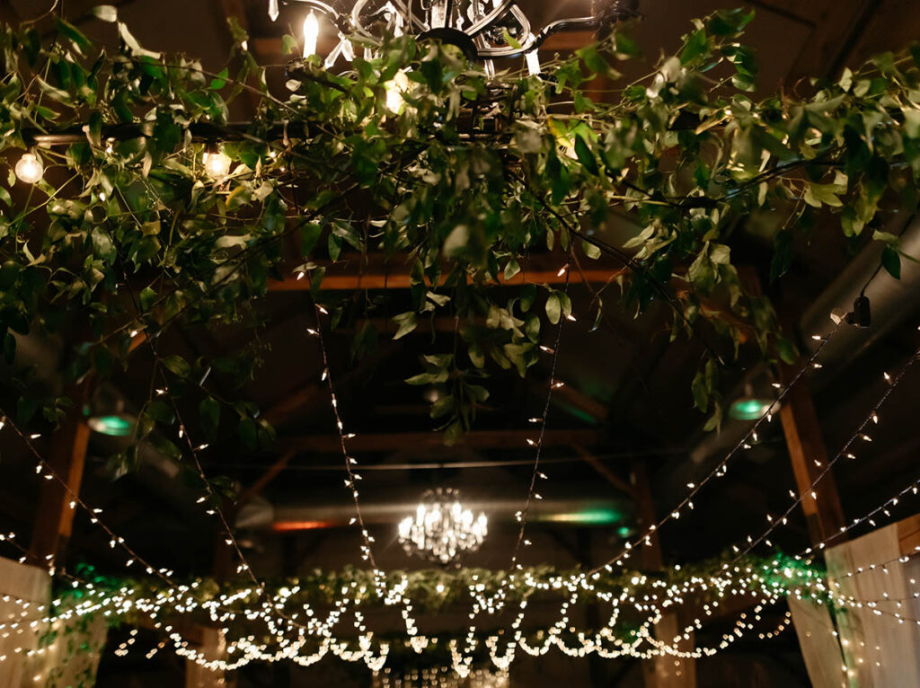 greenery and lights hanging from ceiling for event decoration